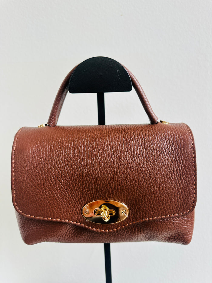 Borsa 100% pelle fiorentina. Borsa a bauletto con manico a mano, tracolla regolabile e tasca interna. Chiusura esterna con gancio dorato. MISURE : 14cm X 18cm 