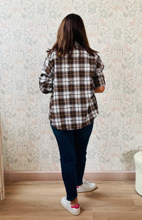 Camicia a quadri con collo alla coreana e strappi decorativi. Taglio leggermente svasato e vestibilità morbida.