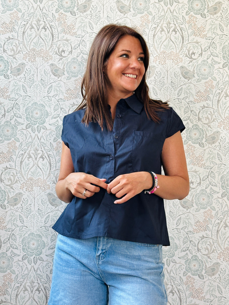 Camicia a manica corta con bottoni e tasca sul davanti. Colore: blu