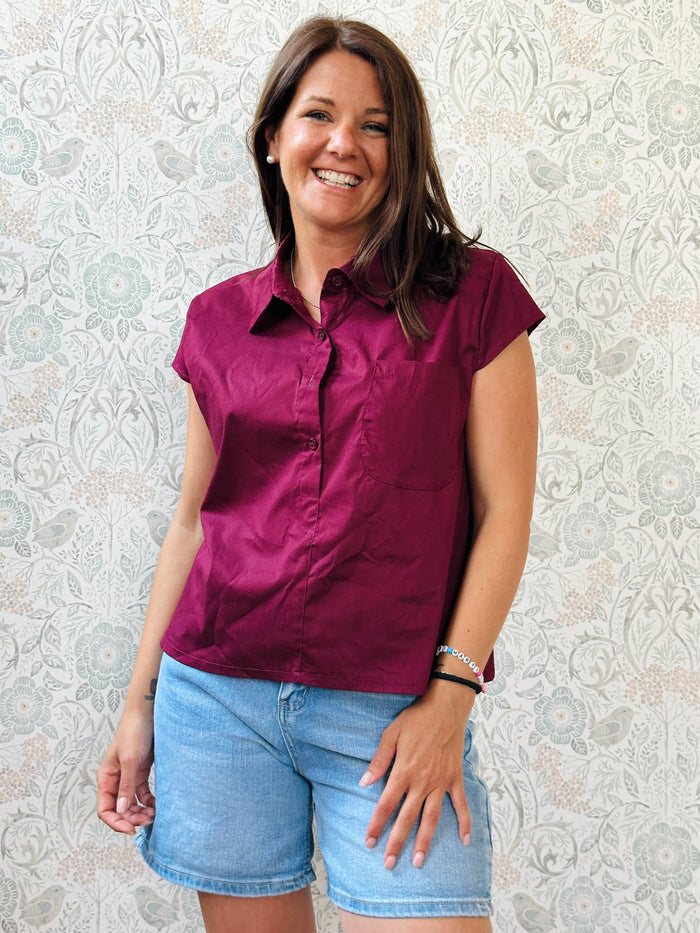 Camicia a manica corta con bottoni e tasca sul davanti. Colore bordeaux