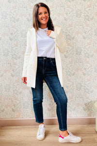Cardigan da donna lungo con cappuccio e tasche a vista aperte sul davanti. 