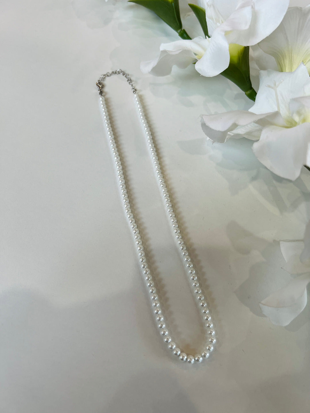 Collana in argento composta da perle sintetiche. Chiusura regolabile. Disponibile in 2 misure: S e M. Gioielli originali. 