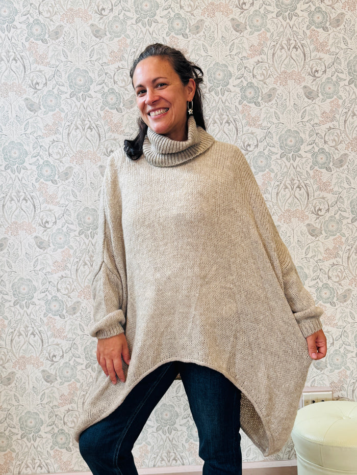 Maglione a trama grossa con collo alto, taglio leggermente svasato e vestibilità molto ampia e morbida. 