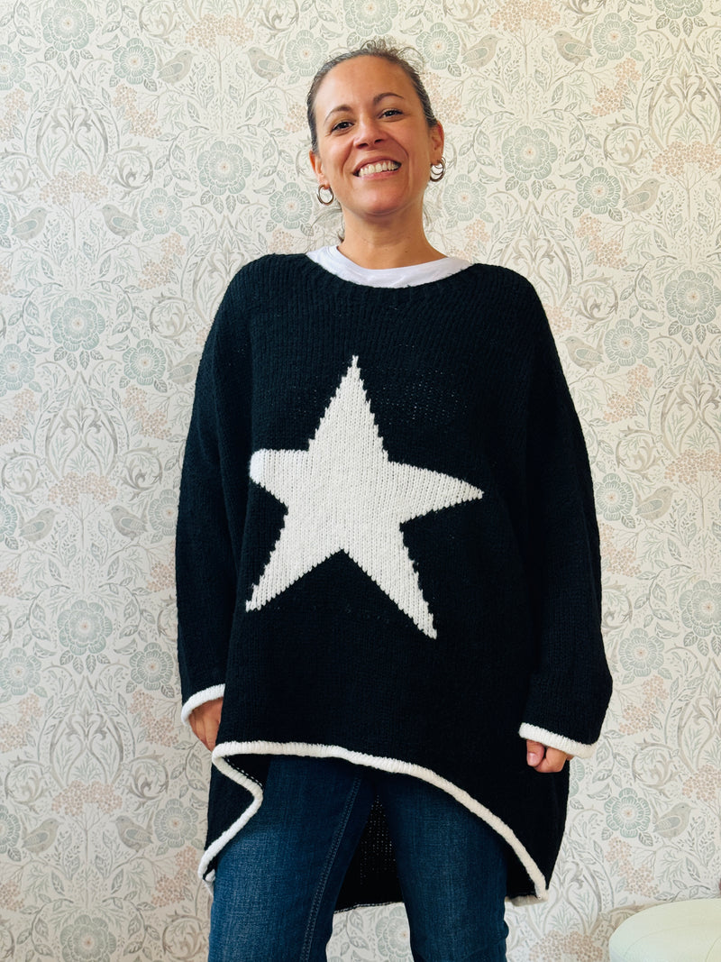Maglione con scollo tondo, ampio e svasato. Dettaglio stella sul davanti e riga a contrasto sui bordi delle maniche e sul bordo finale.   