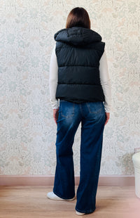 Piumino Smanicato imbottito con chiusura a bottoni clip, tasche laterali e cappuccio. Disponibile dalla taglia S(40) alla L(44). Outfit Must-Haves Made in Italy 