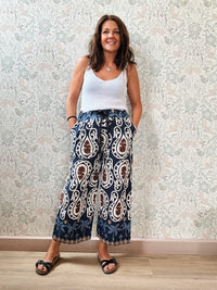 Top con scollo a V fronte e retro. Trama a costine e taglio dritto ed aderente.