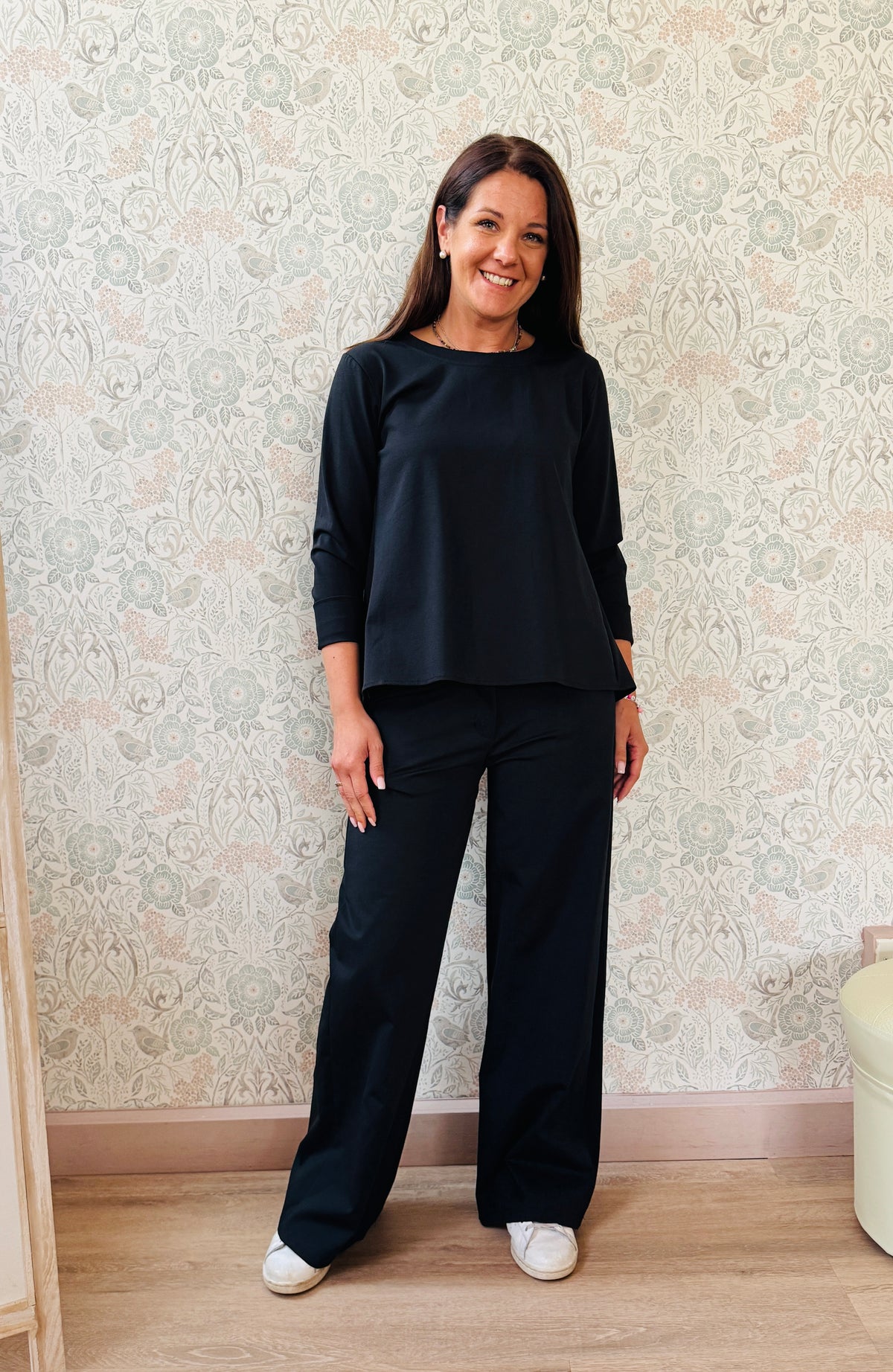 Completo composto da pantaloni con chiusura con zip e cerniera ed elastico sul retro. Taglio a palazzo. Felpa con scollo tondo dal taglio ampio e svasato. 